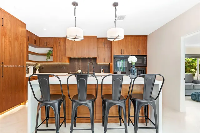 a view of a dining room with furniture wooden floor and chandelier