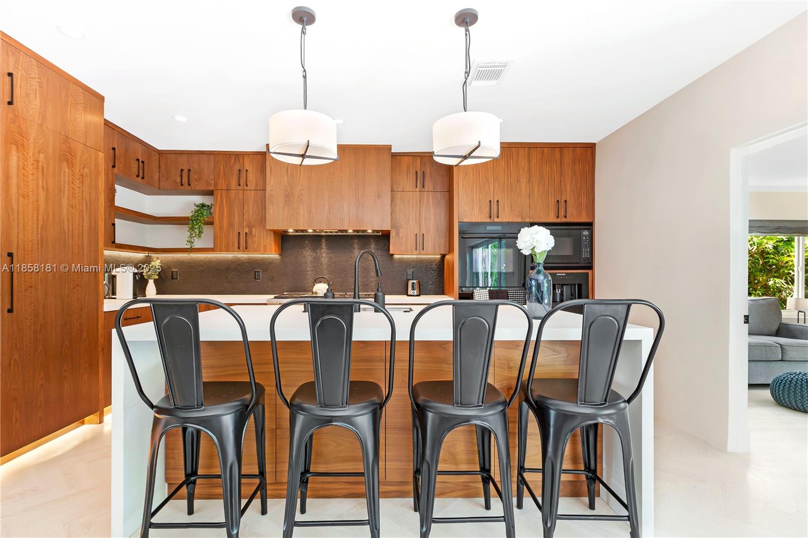 9065 Emerson Avenue Surfside, FL 33154 - Photo 18 of 50 a view of a dining room with furniture wooden floor and chandelier