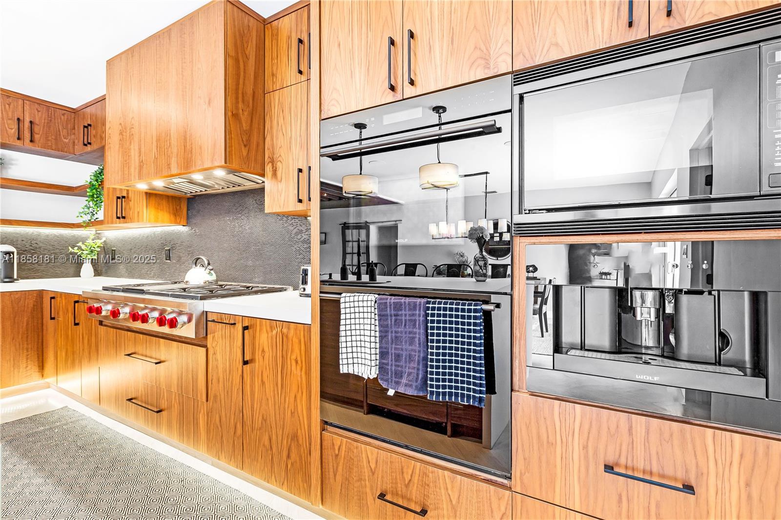 9065 Emerson Avenue Surfside, FL 33154 - Photo 20 of 50 a kitchen with stainless steel appliances granite countertop a stove and a microwave