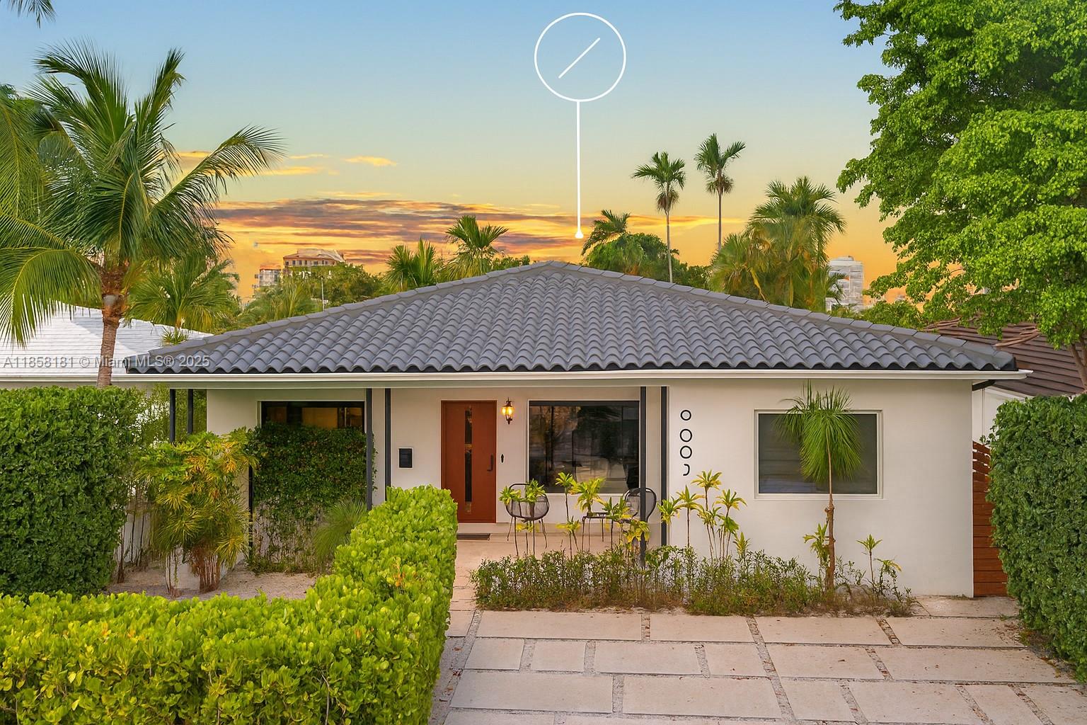 9065 Emerson Avenue Surfside, FL 33154 - Photo 2 of 50 a front view of a house with garden
