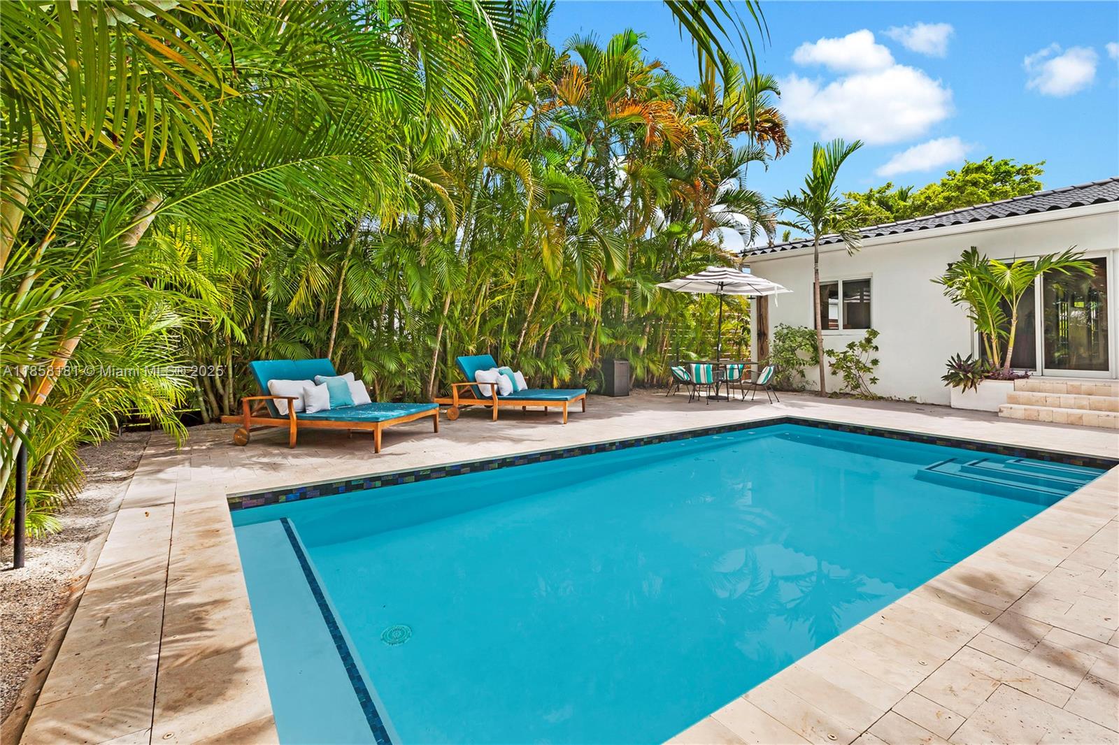 9065 Emerson Avenue Surfside, FL 33154 - Photo 27 of 50 a swimming pool with outdoor seating and yard