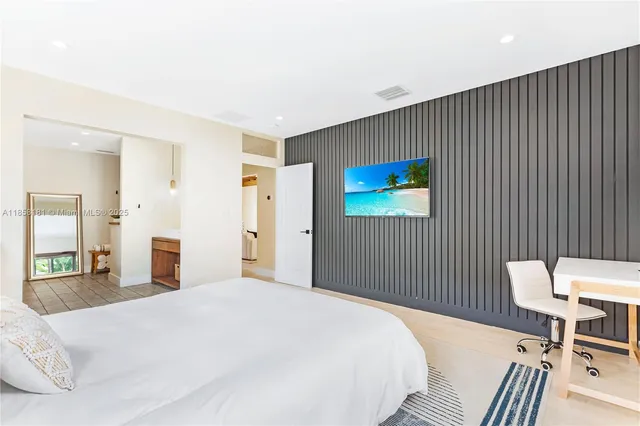 a bedroom with a bed and a chair