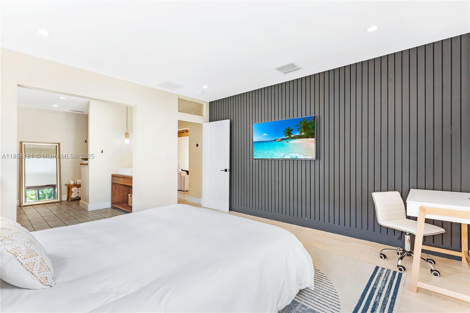 9065 Emerson Avenue Surfside, FL 33154 - Photo 31 of 50 a bedroom with a bed and a chair