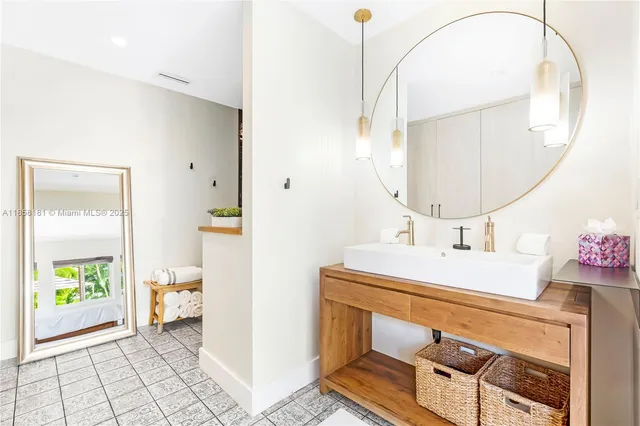 a bathroom with a sink a toilet and a mirror