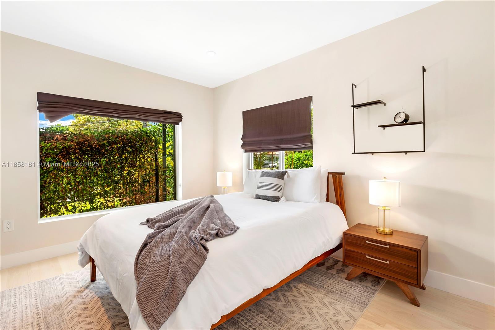 9065 Emerson Avenue Surfside, FL 33154 - Photo 38 of 50 a bedroom with a bed window and a flat screen tv