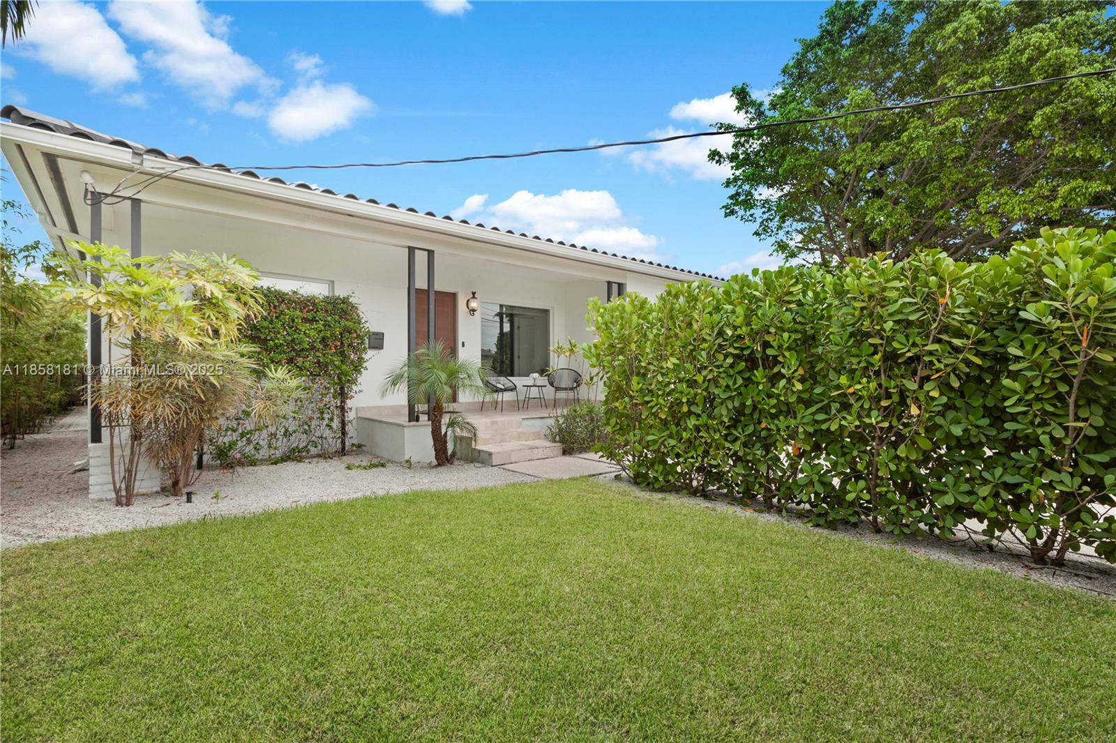 9065 Emerson Avenue Surfside, FL 33154 - Photo 4 of 50 a view of a patio with table and chairs and potted plants