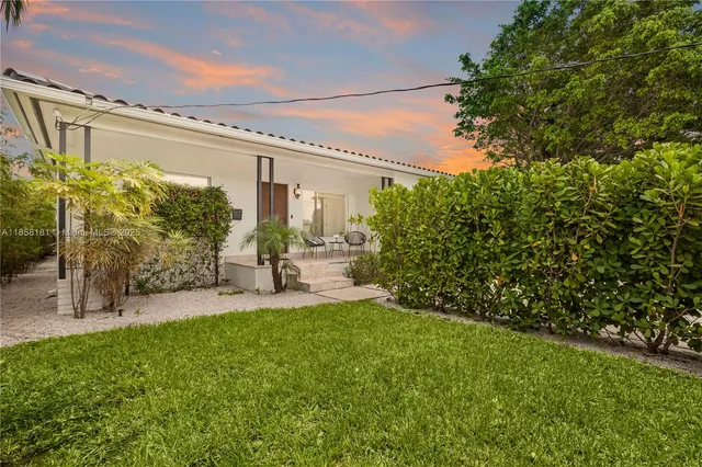 a view of pool with a table and chairs under an umbrella