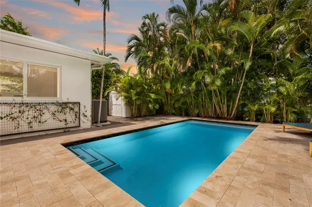 a view of swimming pool with chairs