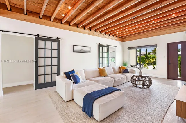 a spacious bedroom with a bed couch and window
