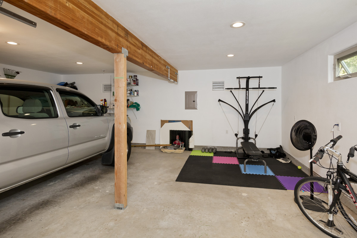 12-7002 Ho'Eunalu Street Pahoa, HI 96778 - Photo 23 of 26 a living room with furniture a flat screen tv and gym equipment