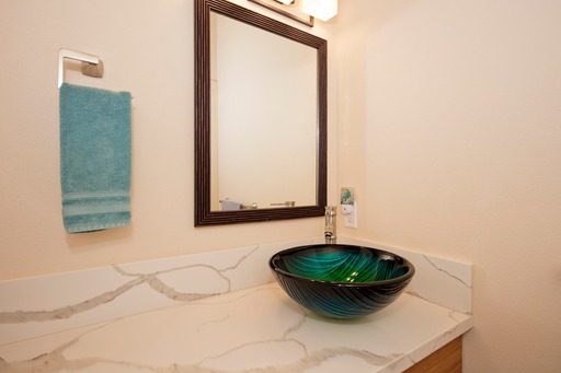 12-7002 Ho'Eunalu Street Pahoa, HI 96778 - Photo 24 of 26 a view of a bathroom with a sink and a mirror