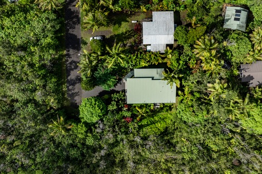 12-7002 Ho'Eunalu Street Pahoa, HI 96778 - Photo 25 of 26 an aerial view of a house with a yard and trees all around
