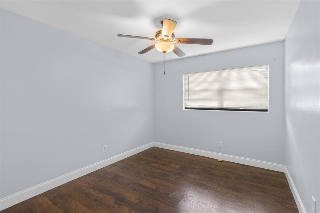 14800 Northeast 8th Court Miami, FL 33161 - Photo 15 of 37 an empty room with wooden floor chandelier fan and windows