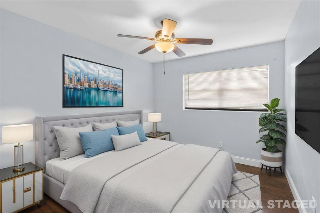 14800 Northeast 8th Court Miami, FL 33161 - Photo 25 of 37 a bedroom with a large bed and a chandelier