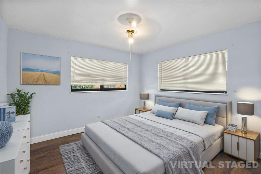 14800 Northeast 8th Court Miami, FL 33161 - Photo 26 of 37 a bedroom with a bed and a chandelier