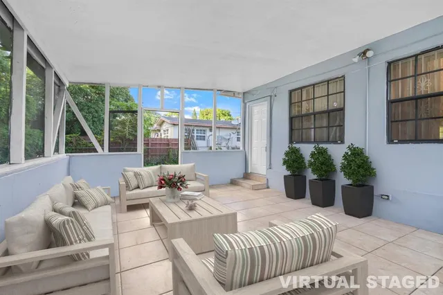 a bedroom with furniture and a potted plant
