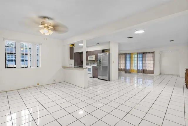 a view of a kitchen with furniture and an empty room