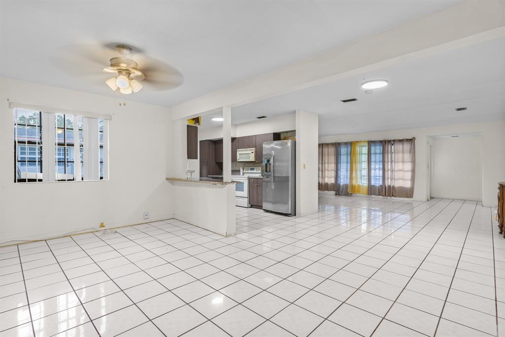 14800 Northeast 8th Court Miami, FL 33161 - Photo 9 of 37 a view of a kitchen with furniture and an empty room