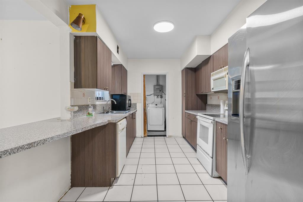 14800 Northeast 8th Court Miami, FL 33161 - Photo 10 of 37 a kitchen with stainless steel appliances granite countertop a refrigerator and a stove top oven