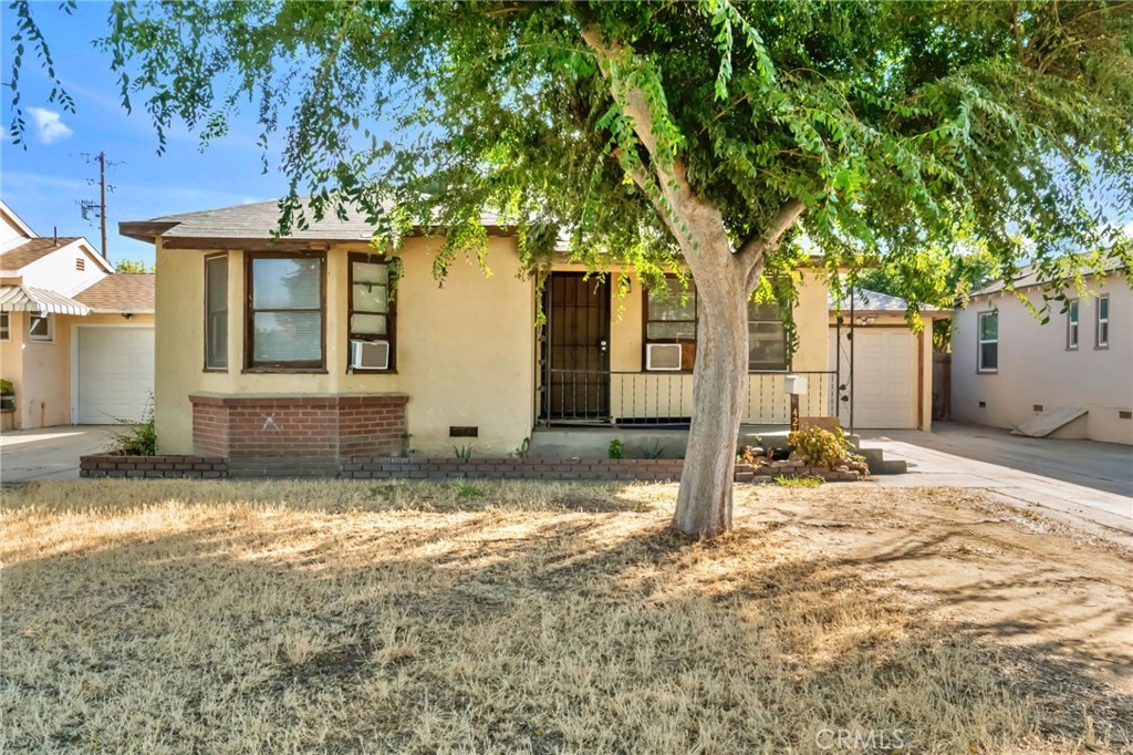 421 South L Street Madera, CA 93637 - Photo 1 of 1 a view of a house with backyard and tree