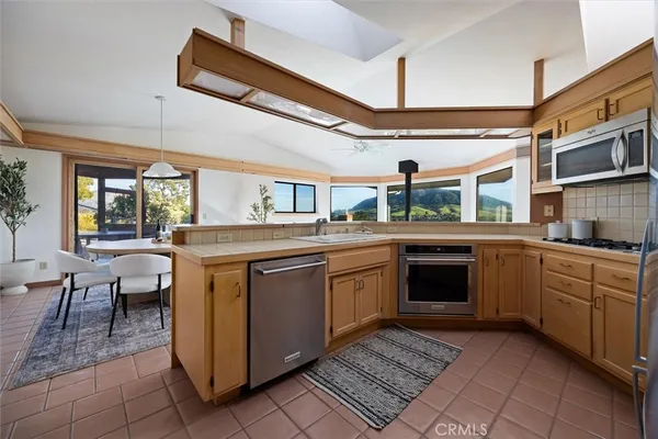 a kitchen with a sink cabinets and window