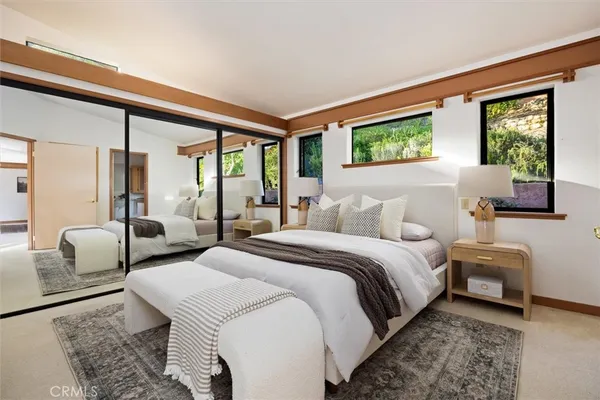a bedroom with double bed and a window