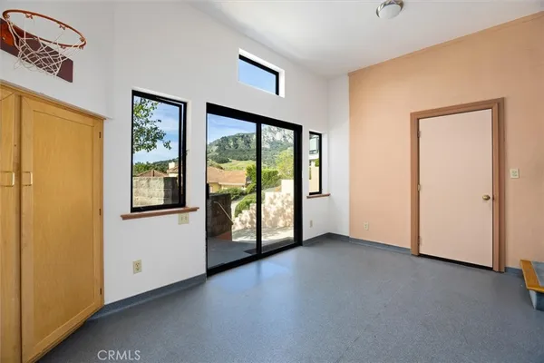 a swimming pool with chairs and wooden door