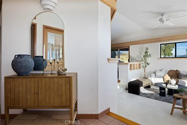 a living room with furniture and a floor to ceiling window