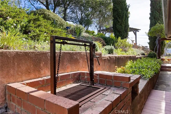 a view of a house with a table and chairs under an umbrella