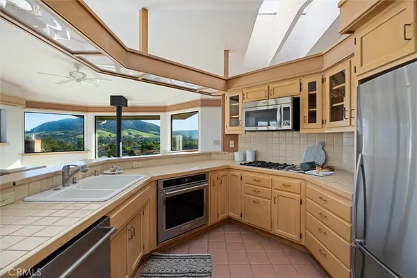 a kitchen with stainless steel appliances granite countertop a sink and cabinets