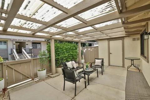 a dining room with furniture and a floor to ceiling window