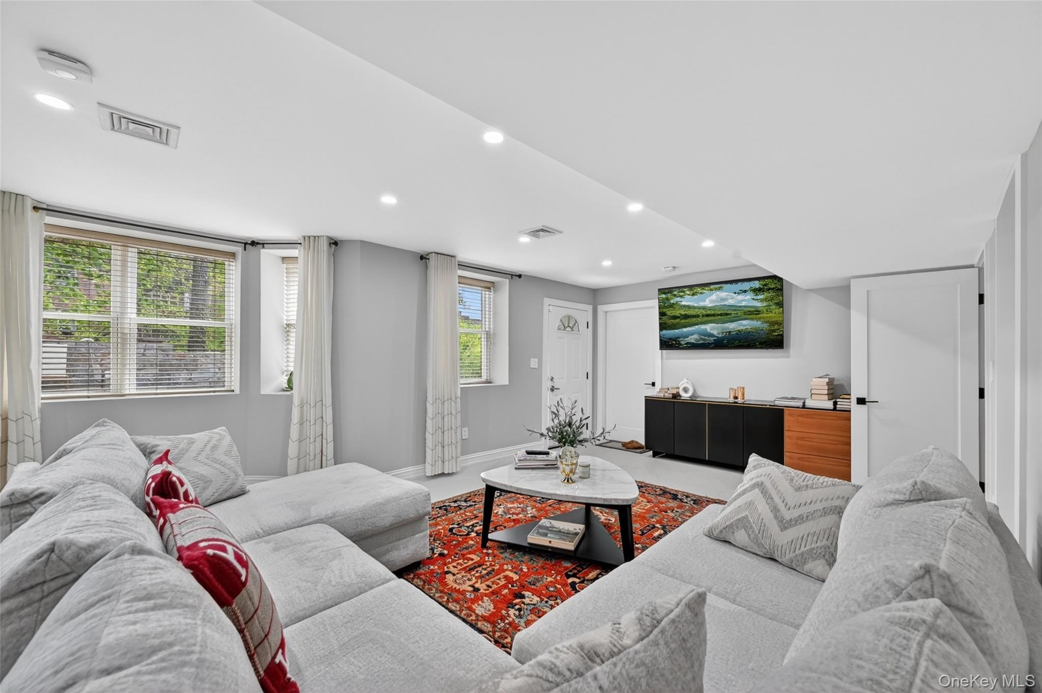 65 Wildway Bronxville, NY 10708 - Photo 24 of 42 Spacious living area featuring light gray walls and recessed lighting