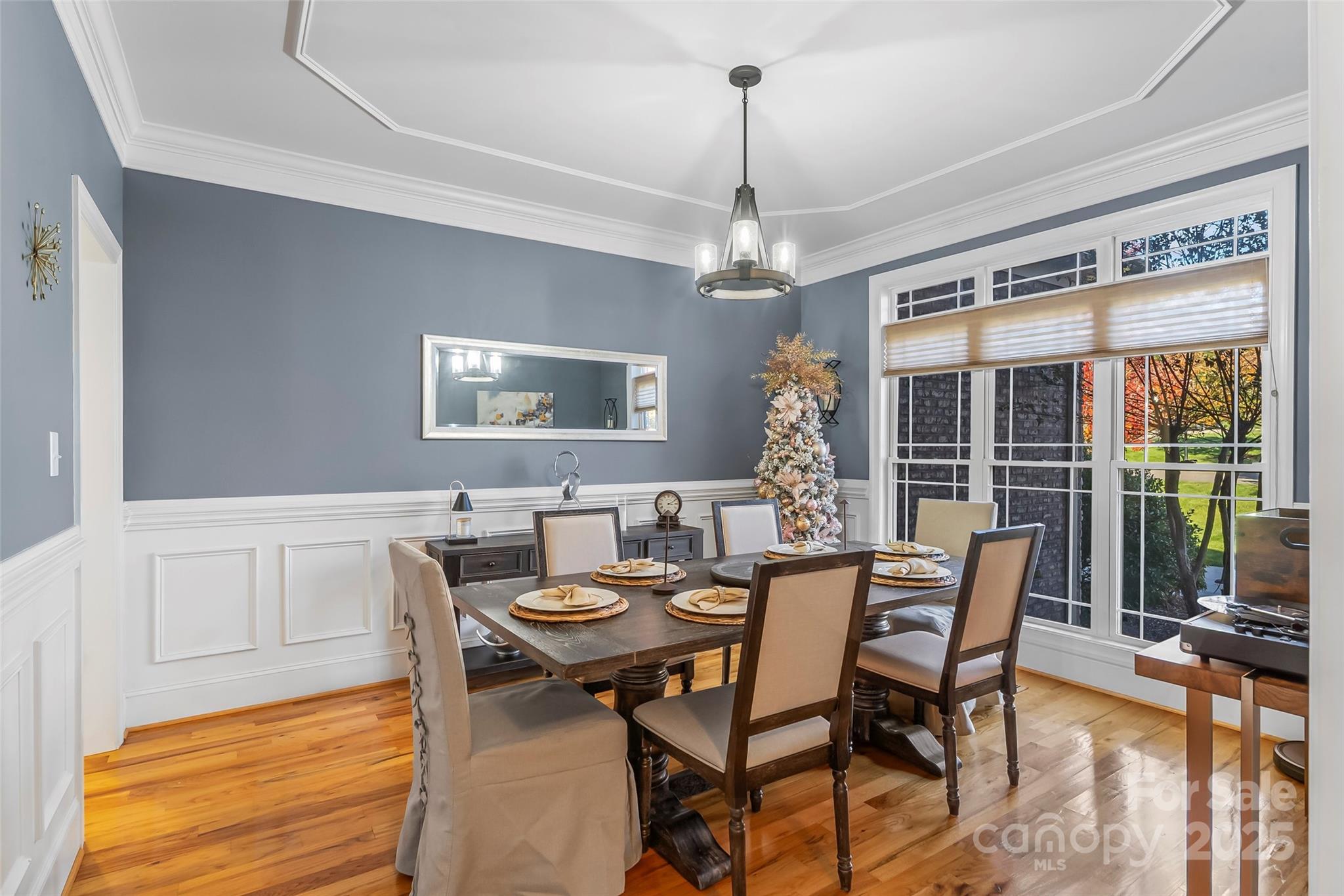 5836 Bakers Point Hickory, NC 28602 - Photo 19 of 48 a dining room with furniture a chandelier and wooden floor