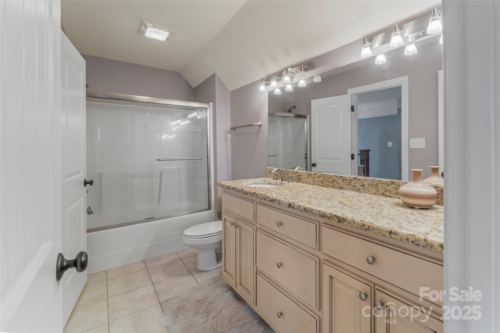 5836 Bakers Point Hickory, NC 28602 - Photo 28 of 48 a bathroom with a granite countertop sink a toilet a mirror and shower