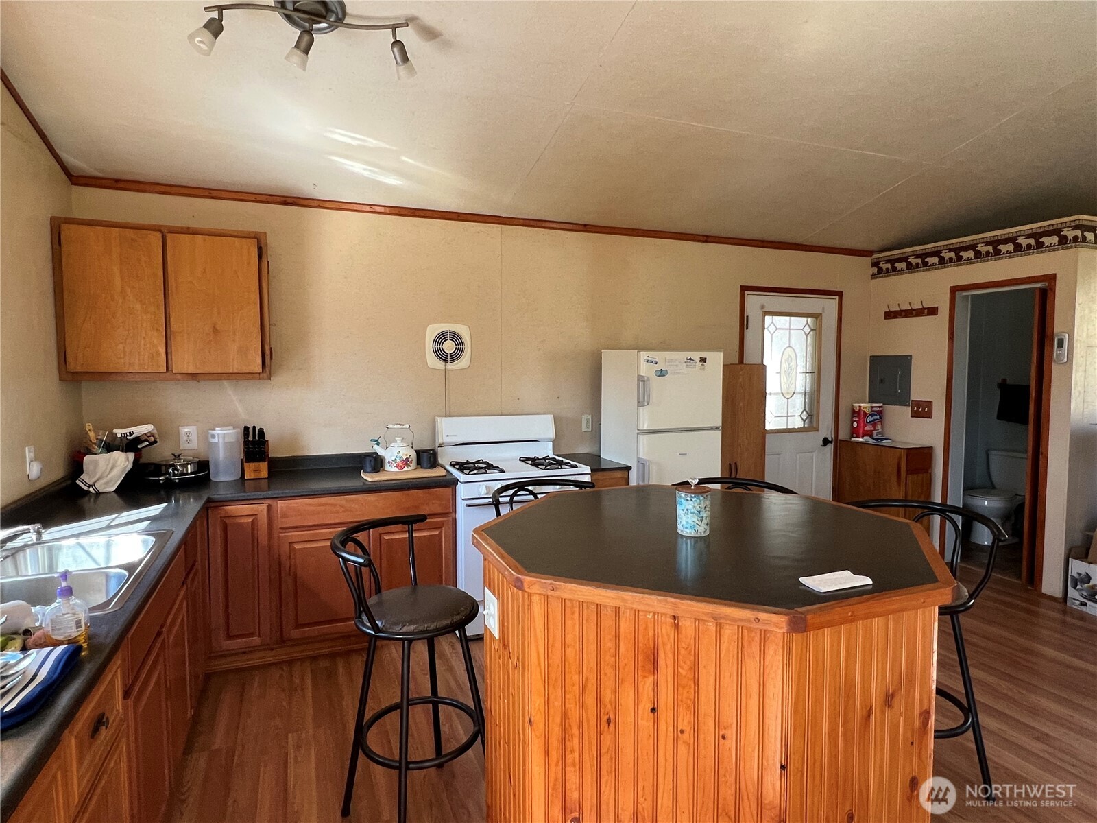 113 Eagles Bluff Road Oroville, WA 98844 - Photo 11 of 33 a kitchen with stainless steel appliances granite countertop a sink dishwasher stove refrigerator and cabinets