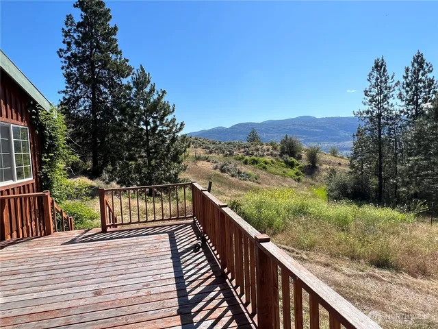 a view of a balcony with wooden fence and floor