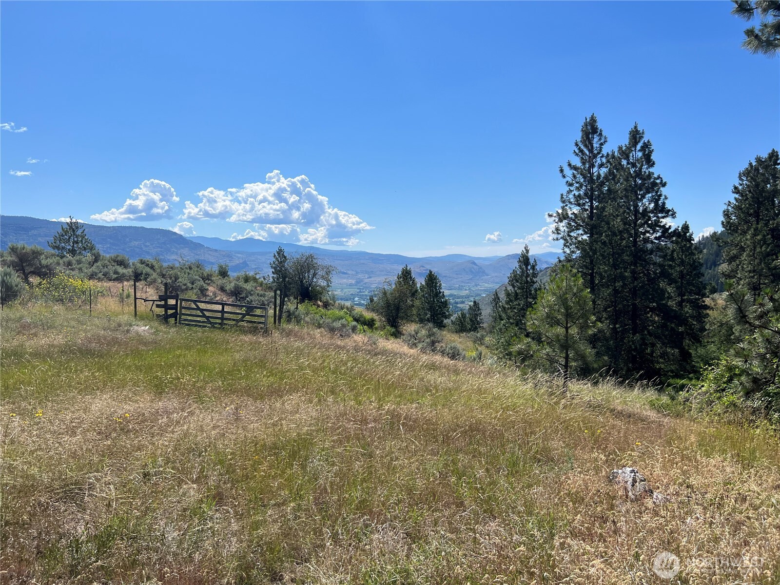 113 Eagles Bluff Road Oroville, WA 98844 - Photo 25 of 33 a view of a town with mountains in the background