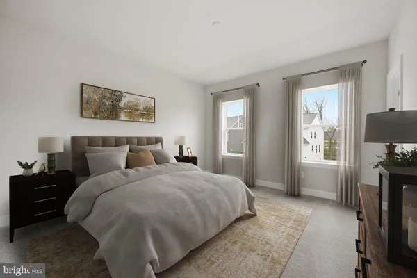 a bedroom with bed tv and window