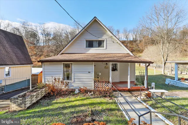 a view of a house with backyard porch and sitting area