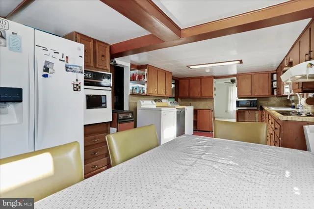 a kitchen with stainless steel appliances granite countertop a refrigerator and a stove top oven