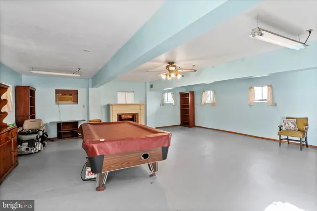 a living room with furniture a flat screen tv and a large window