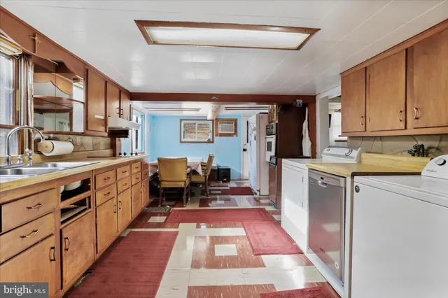 a kitchen with sink window and cabinets