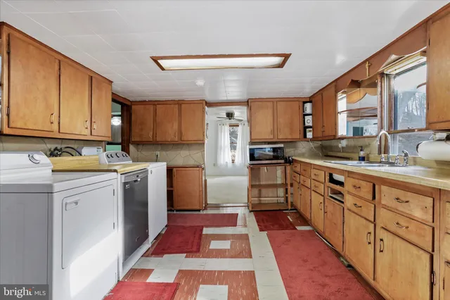 a kitchen with stainless steel appliances granite countertop a sink and dishwasher a stove top oven with wooden floor
