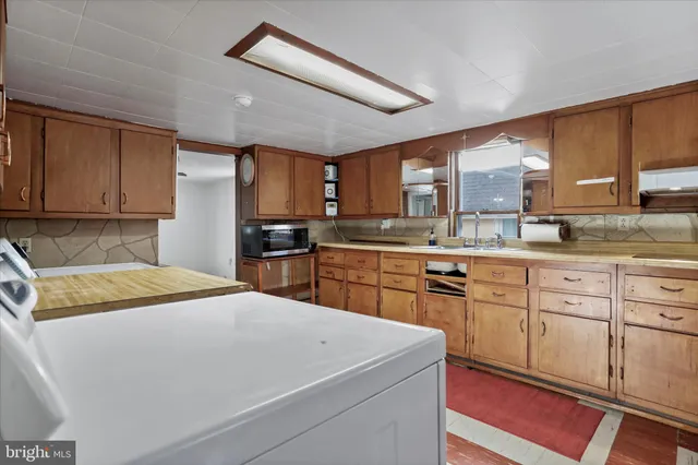 a kitchen with a sink a stove and cabinets