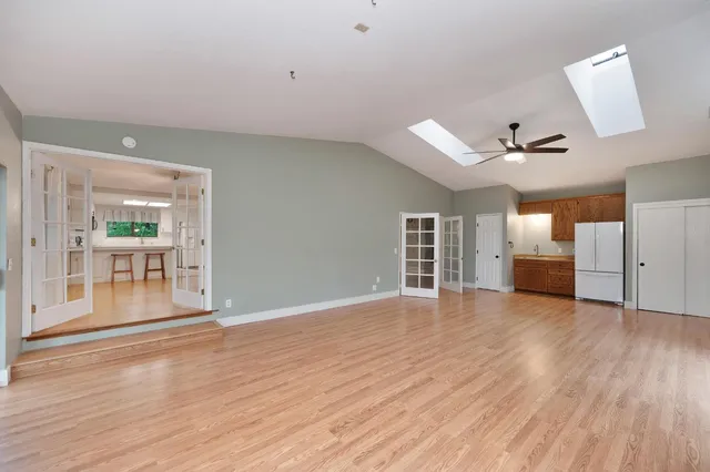 a view of an empty room with a ceiling fan