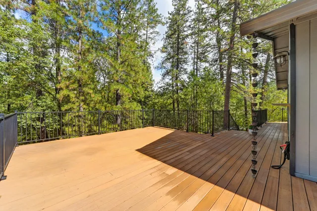 a view of balcony with wooden floor and fence