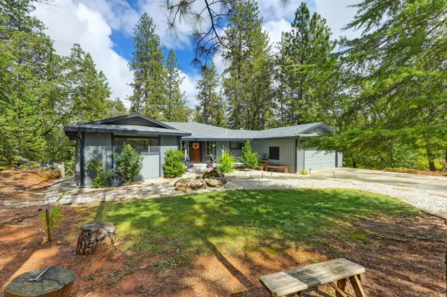 a view of a house with backyard sitting area and garden