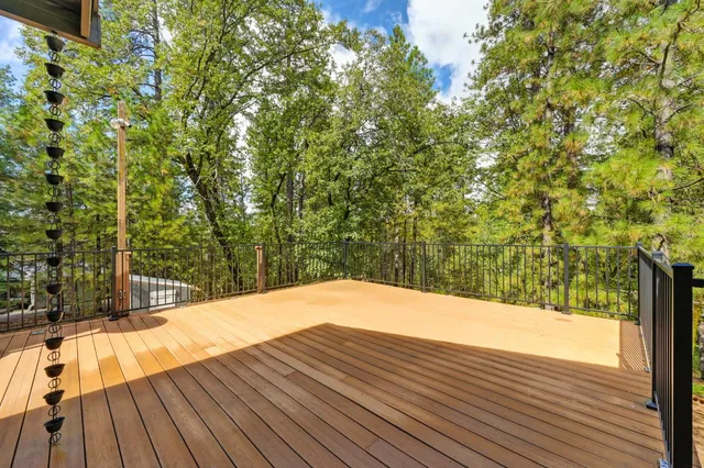 a backyard of a house with a fountain and large trees