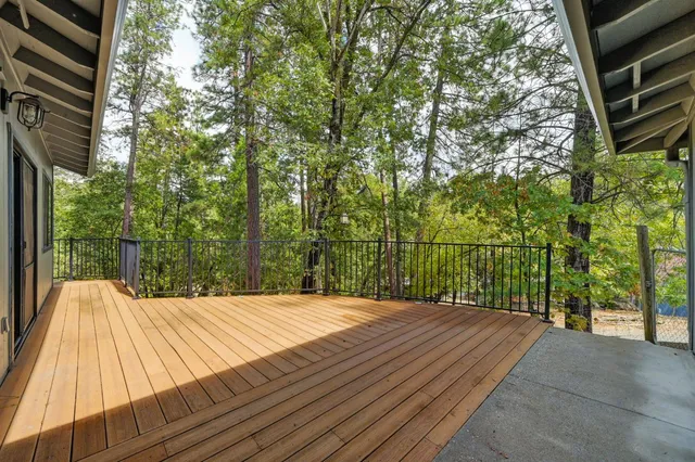 a view of a backyard with large trees