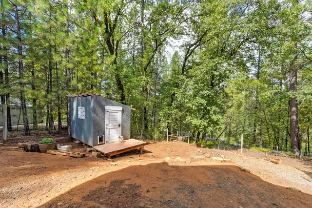 a view of a backyard with a table and chairs